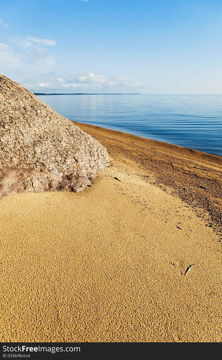 Granite boulder of glacial moraine left on the shore of Chudsky Lake ( Estonian title: Peipsi). Pskov region. Russia. Granite boulder of glacial moraine left on the shore of Chudsky Lake ( Estonian title: Peipsi). Pskov region. Russia