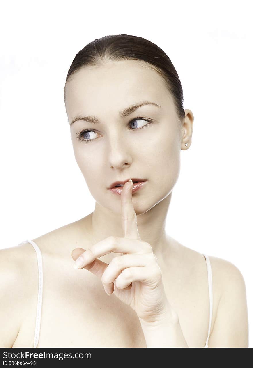 Young girl with her finger over her mouth isolated on white