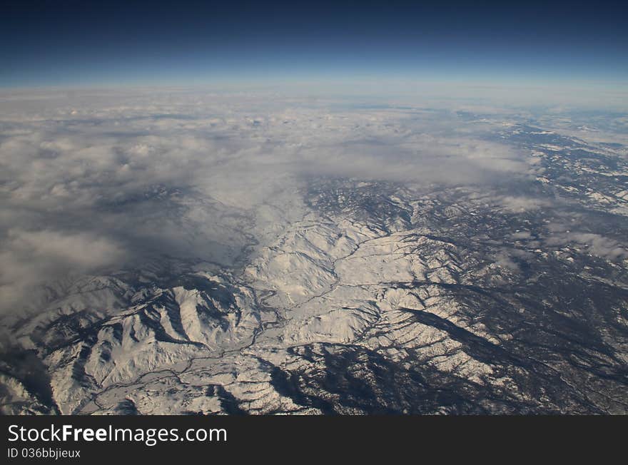 Aerial view of snow covered rockies