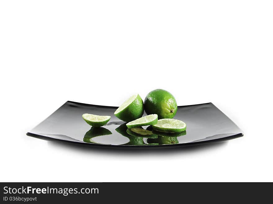 Sliced Limes On Black Plate Isolated