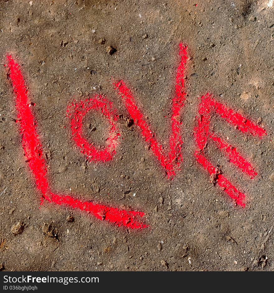 Word love written with crayon on concrete. Word love written with crayon on concrete