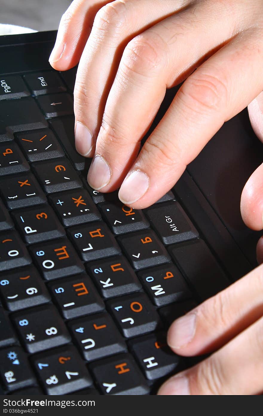 Hands typing at the laptop keyboard. Hands typing at the laptop keyboard