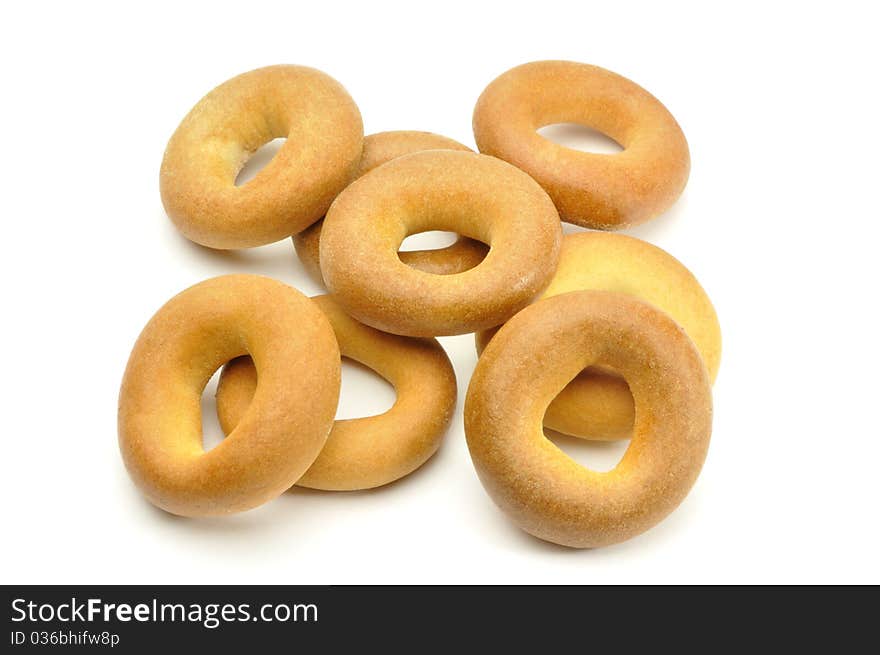 heap of small bagels on white background