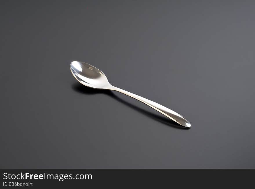 Silver spoon on a black table