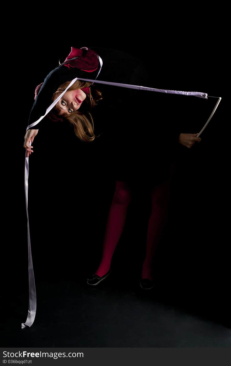 Beautiful girl with red stockings and ribbon on black background