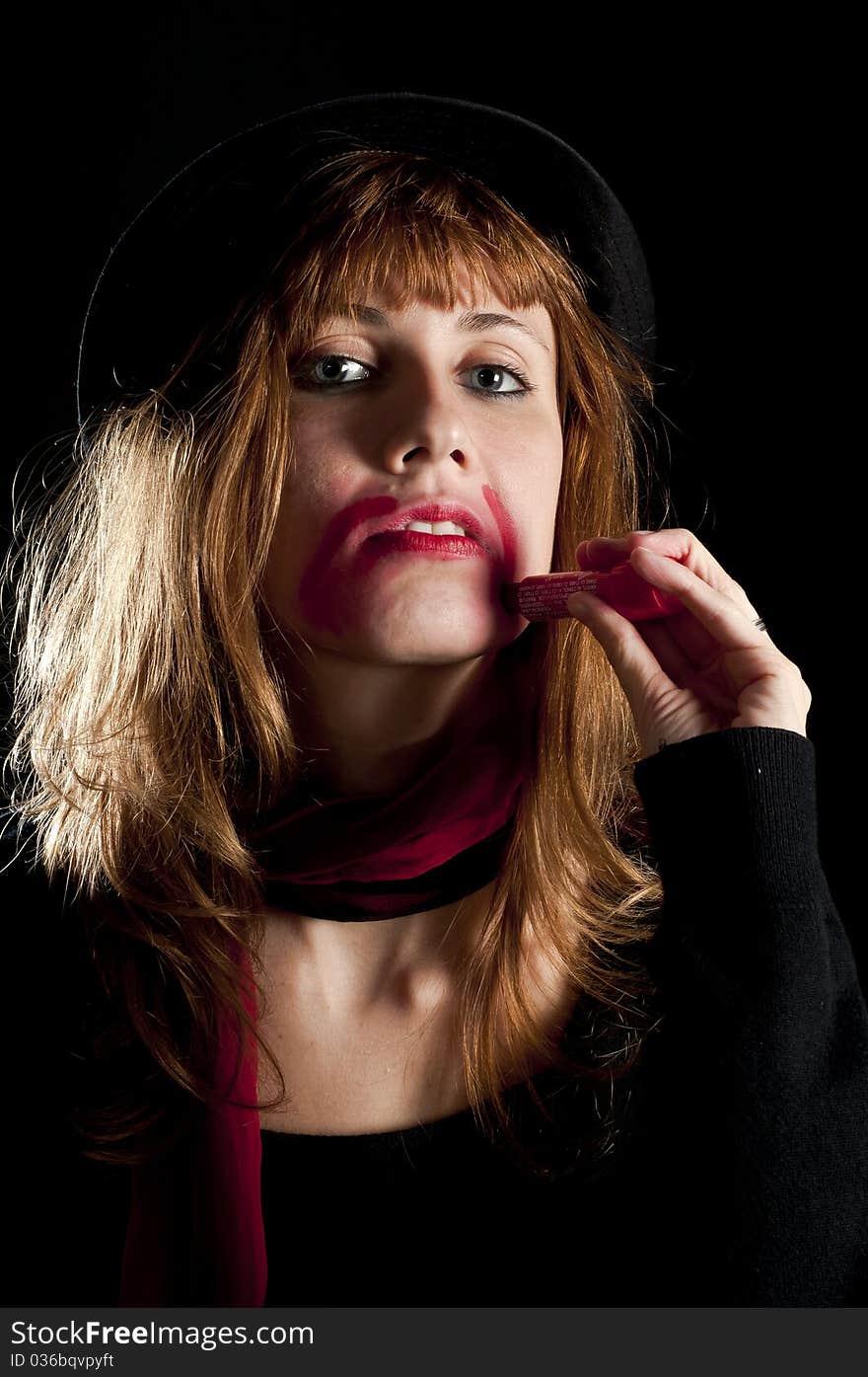 Girl turns her face with lipstick on black background