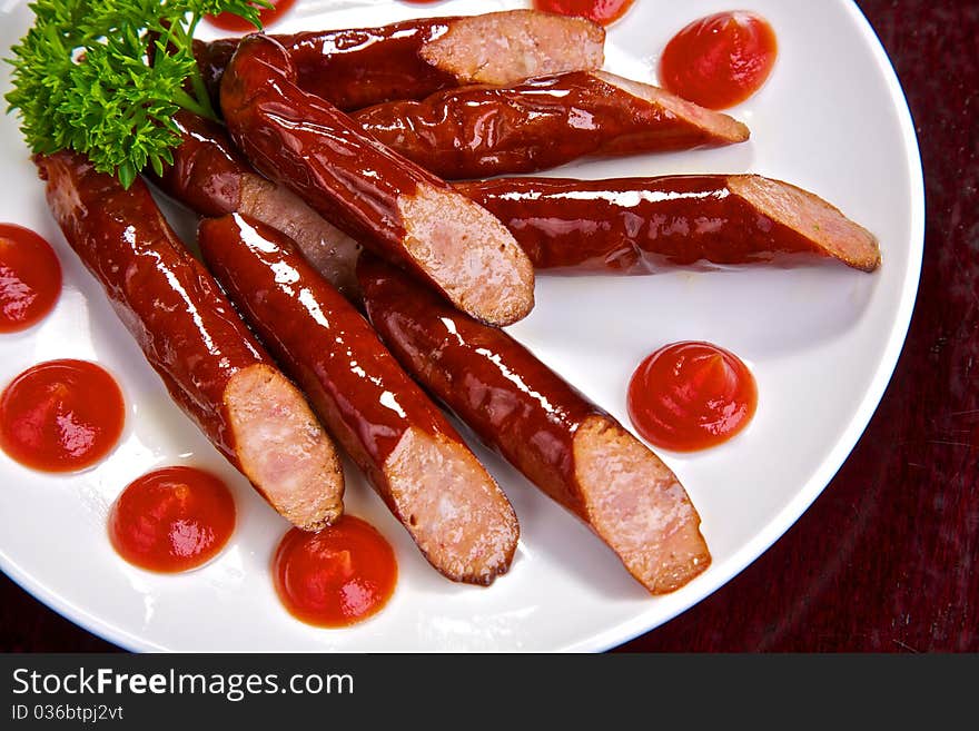 Appetizing Bavarian sausages with sauce and greens