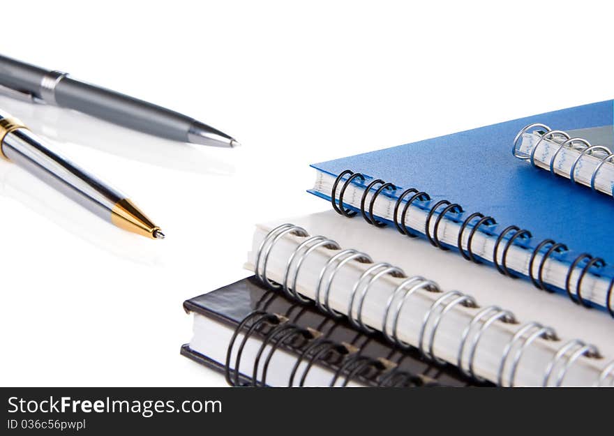 Pen and notepad isolated on white background