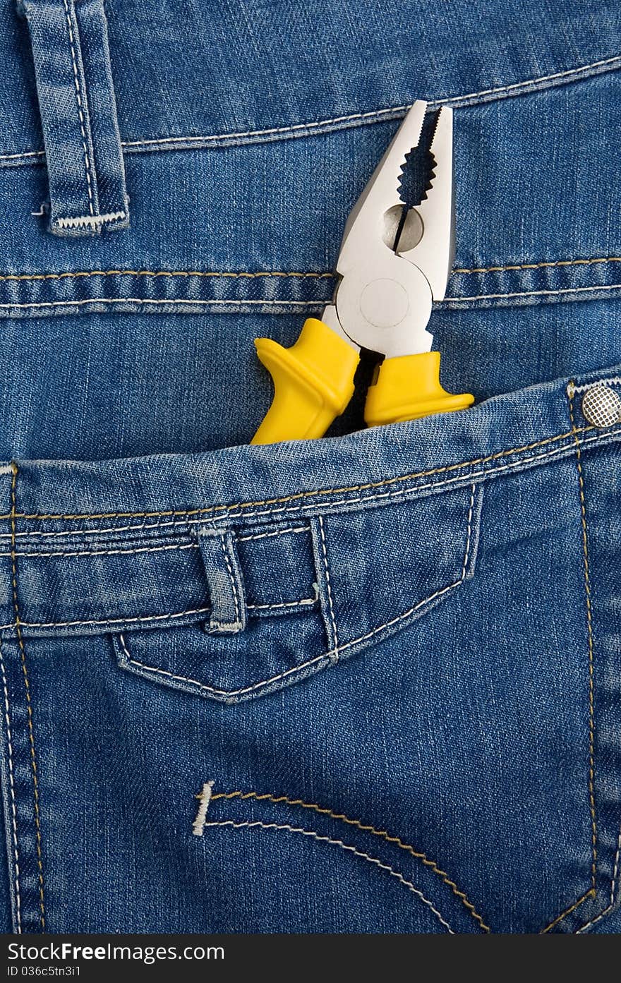 Pliers in pocket jeans