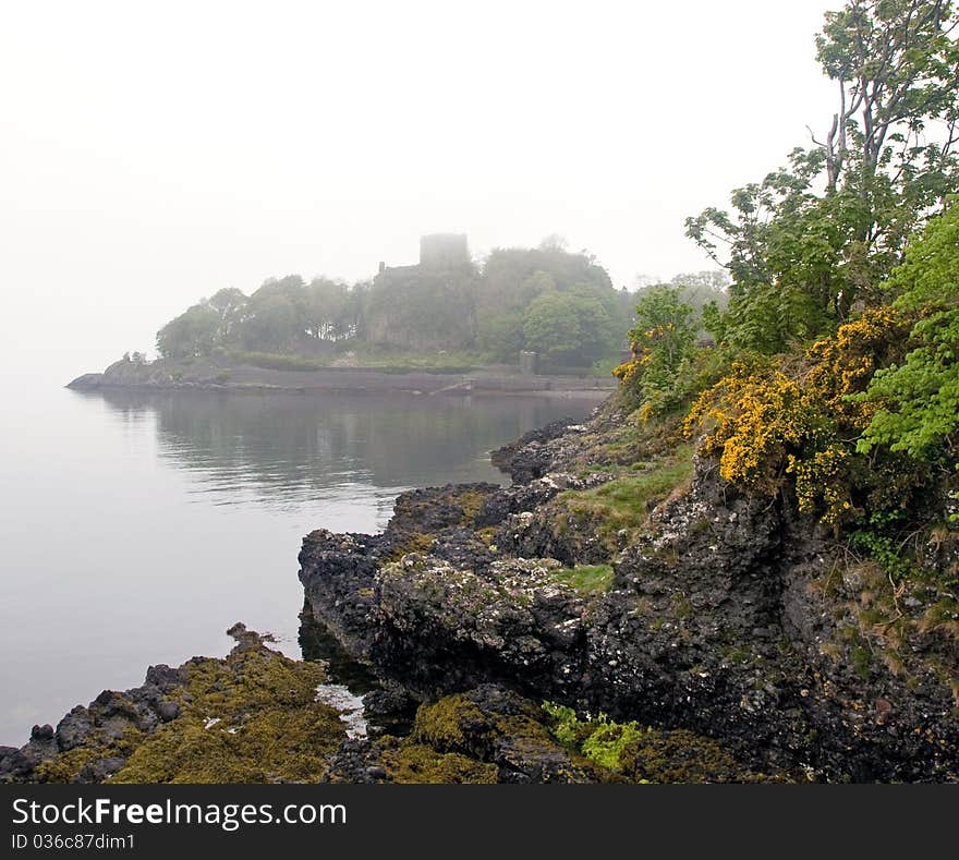 Rocks and misty scottish castle