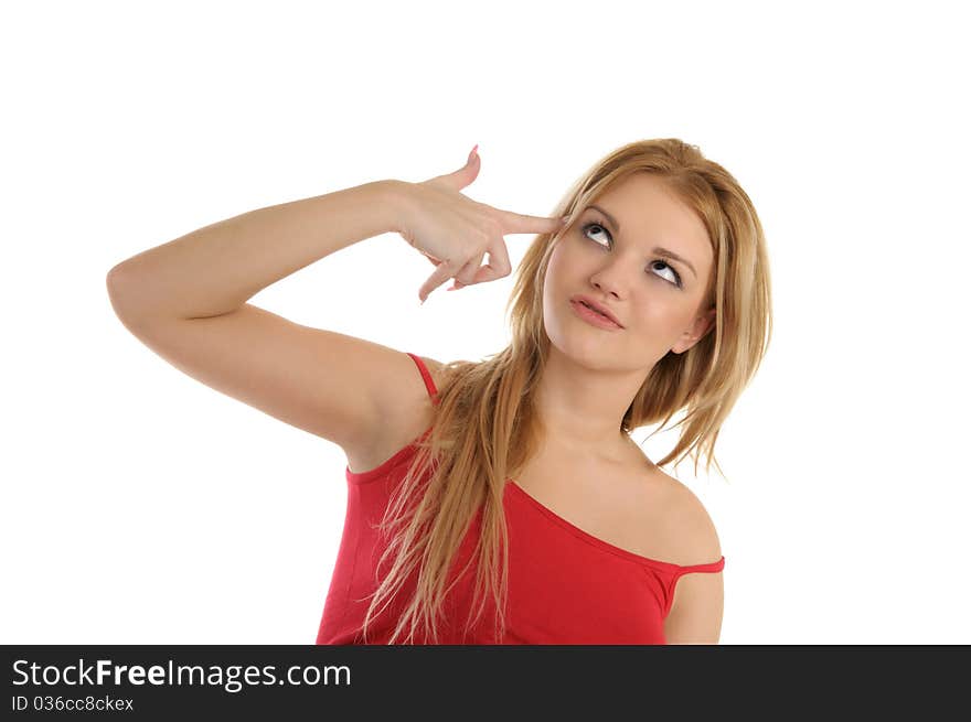 Young woman holds finger at temple isolated in white