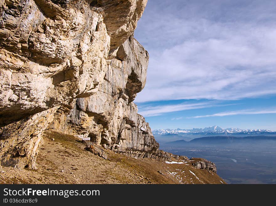 View on Mont-Blanc snow caps over Geneva valley and rock cliff in front