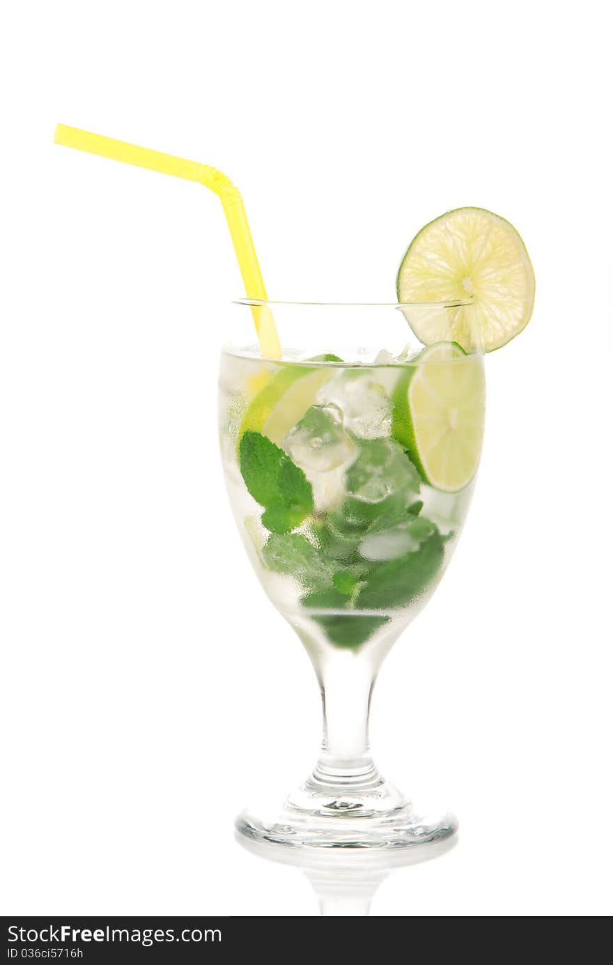 Classic Mojito cocktail drink with alcohol, rum, lime, spring of mint, sprite soda, syrup and yellow straw in cocktail glass isolated on a white background