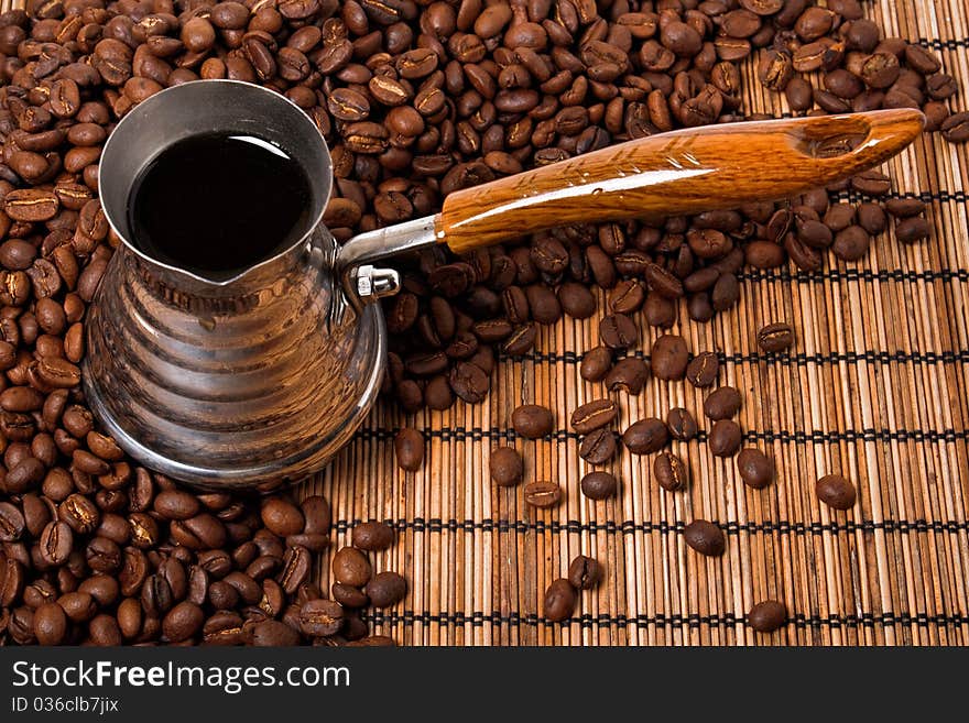 Roasted coffee beans and coffee pot