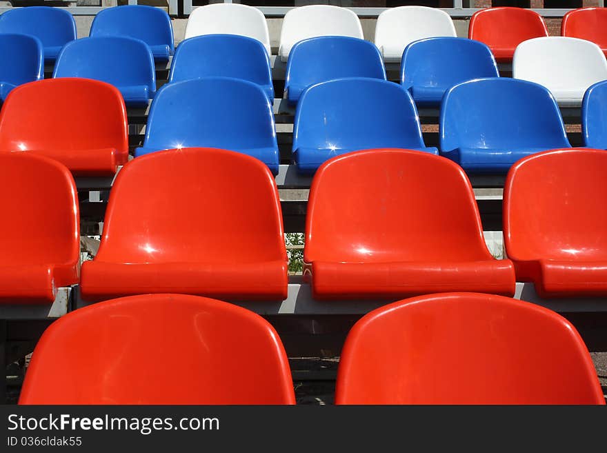 Rows of plastic seats on stadium