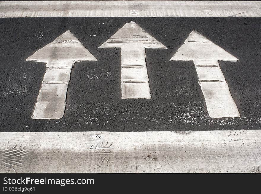 White arrows painted on road