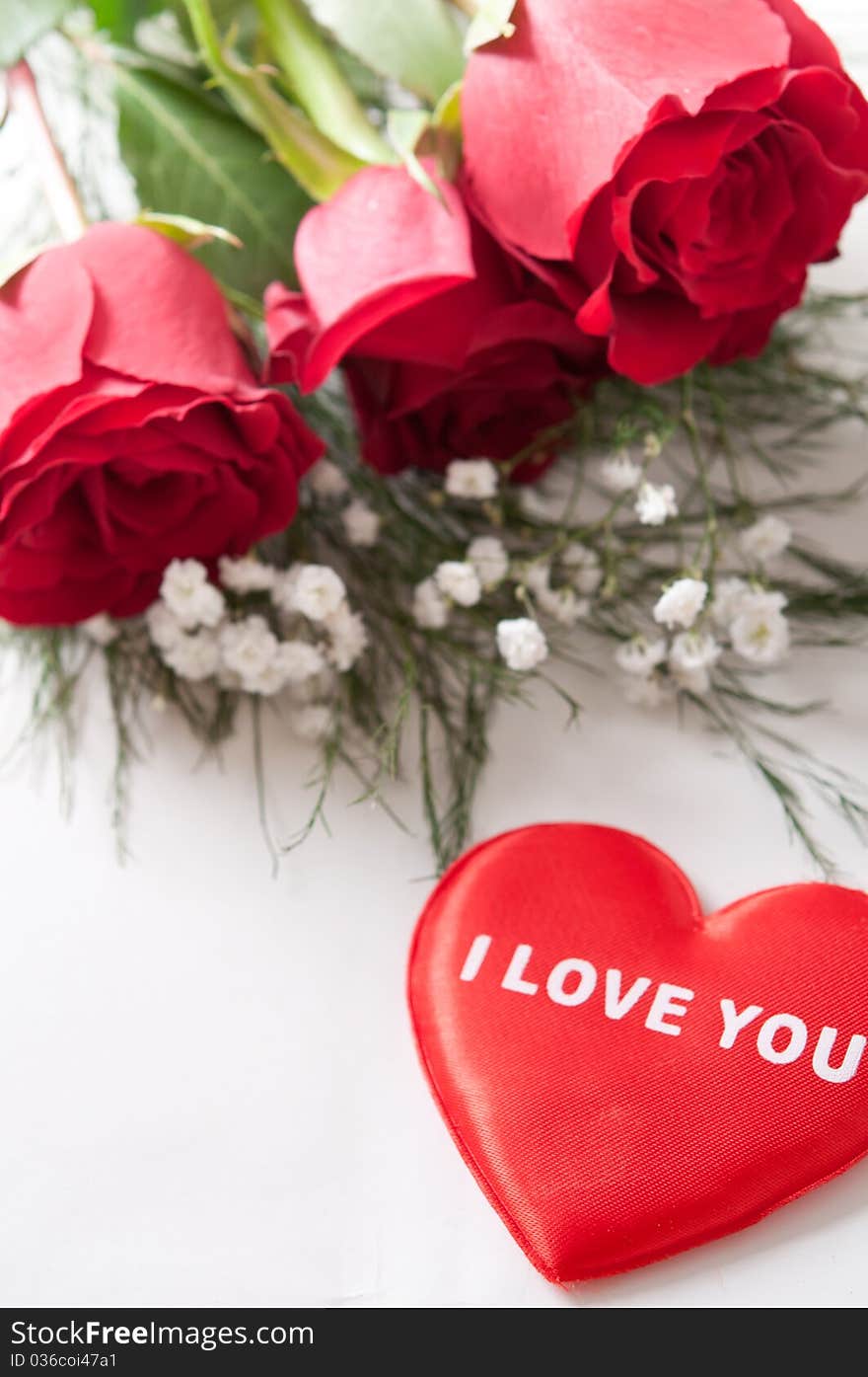 Red roses with Valentine heart on white. Red roses with Valentine heart on white