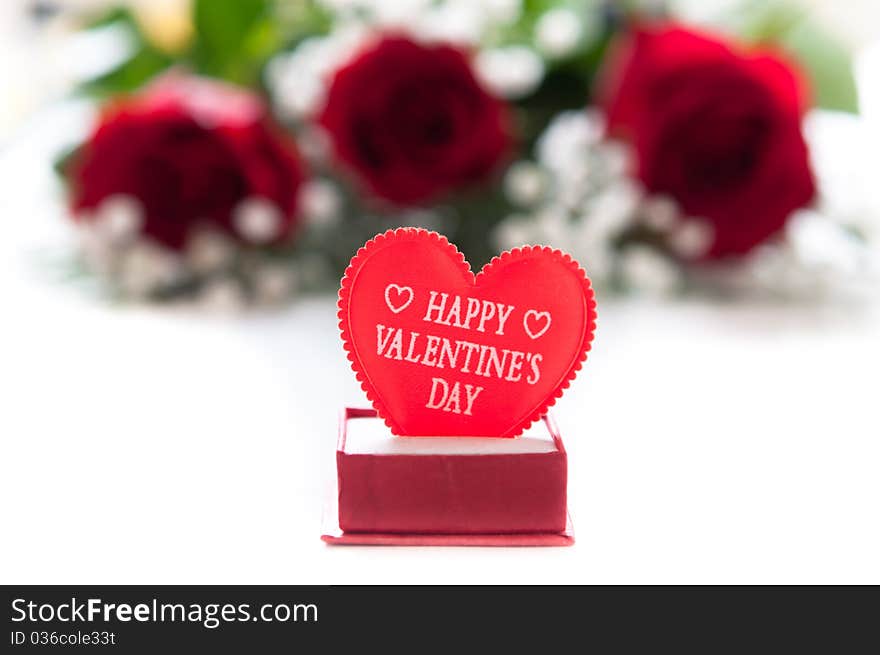 Red roses with Valentine heart on white. Red roses with Valentine heart on white