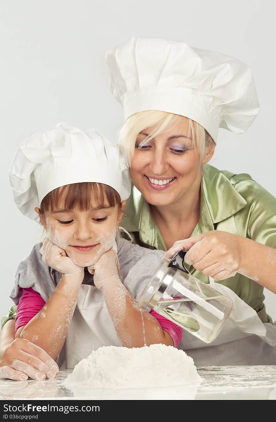 Mother And Daughter Preparing Dough