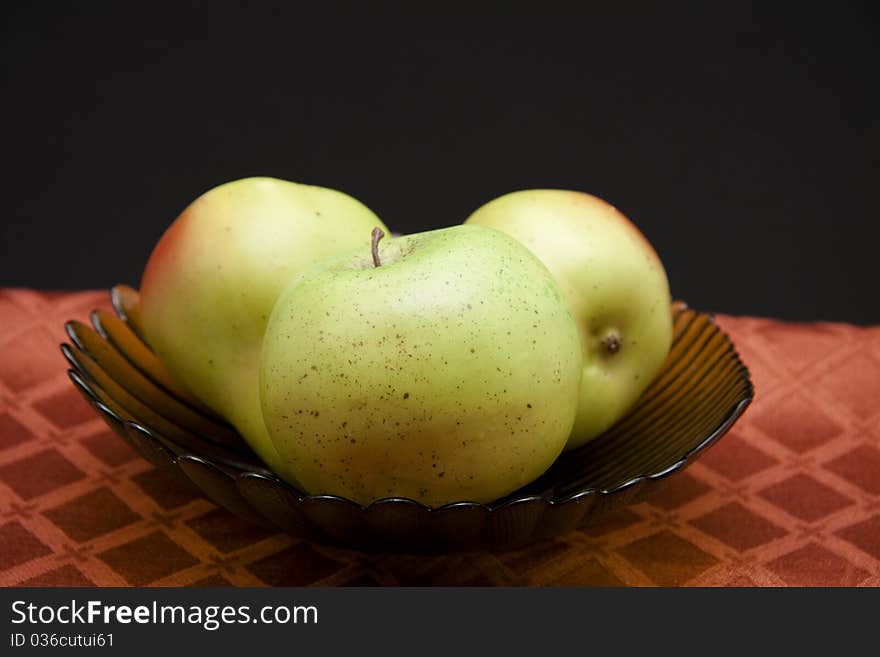 Apple and pears in the glass bowl