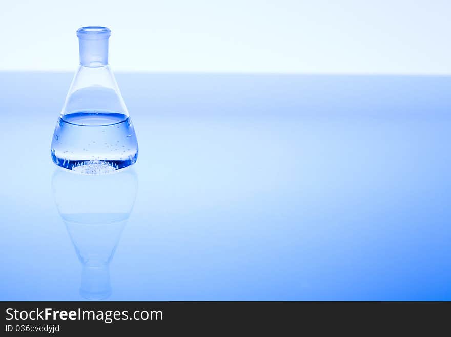 Laboratory glass and water. Blue scene.