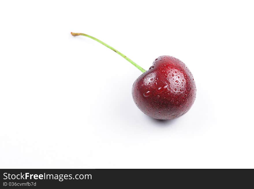 There is a cherry with drop of water. There is a cherry with drop of water