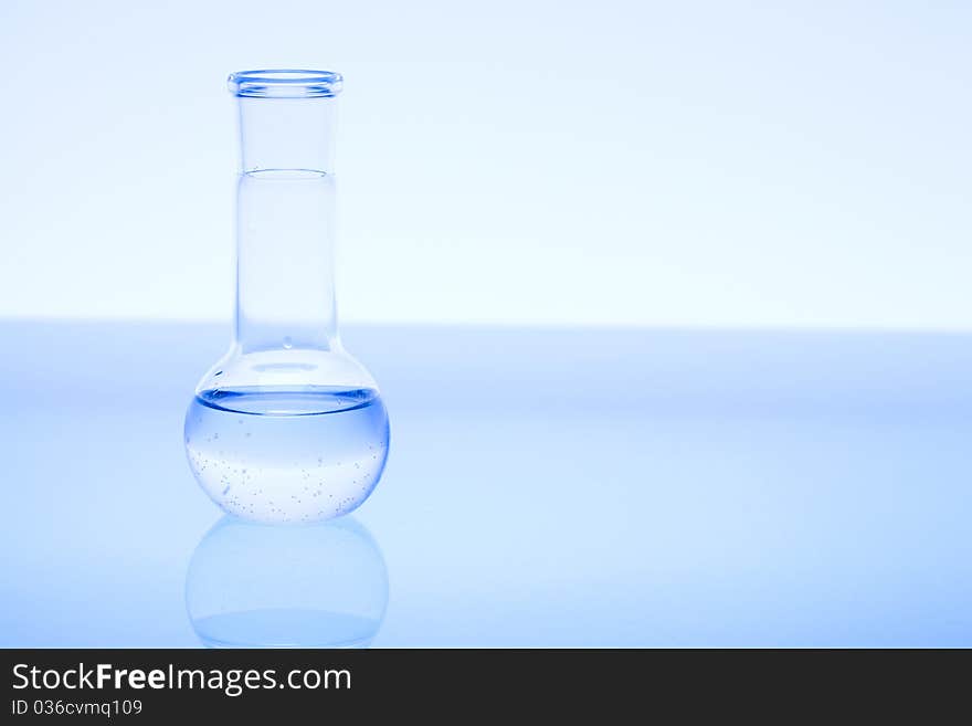 Laboratory glass and water. Blue scene.