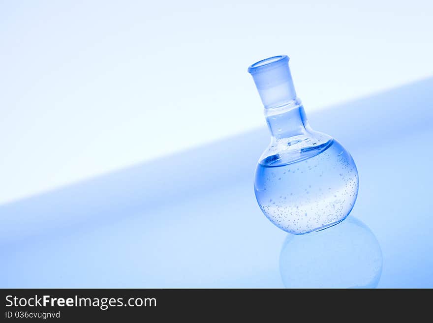 Laboratory glass and water. Blue scene.