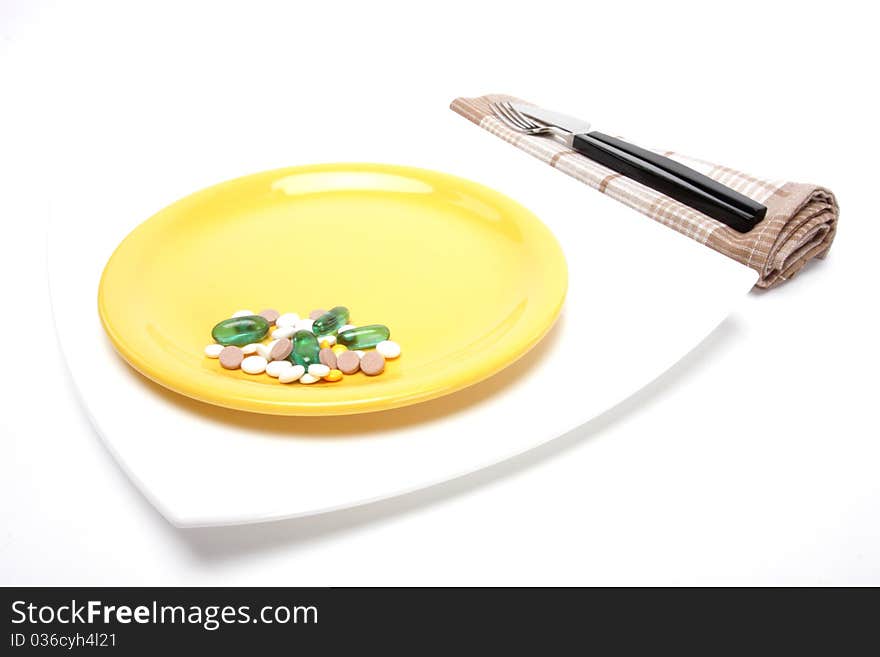 Place setting with plate and pills. Place setting with plate and pills