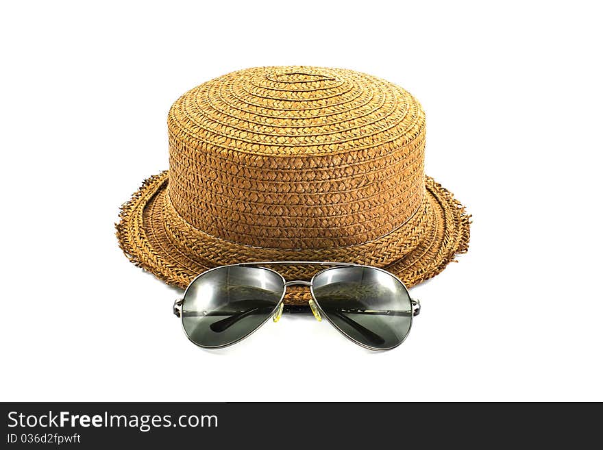 Straw hat and sunglasses isolated on a white background