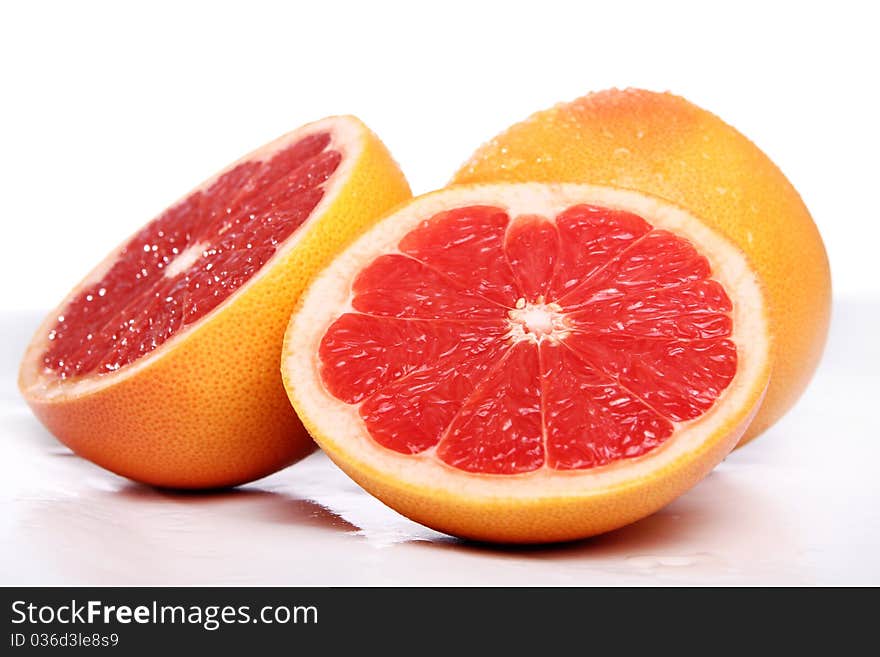 Fresh and wet grapefruit on white background. Fresh and wet grapefruit on white background