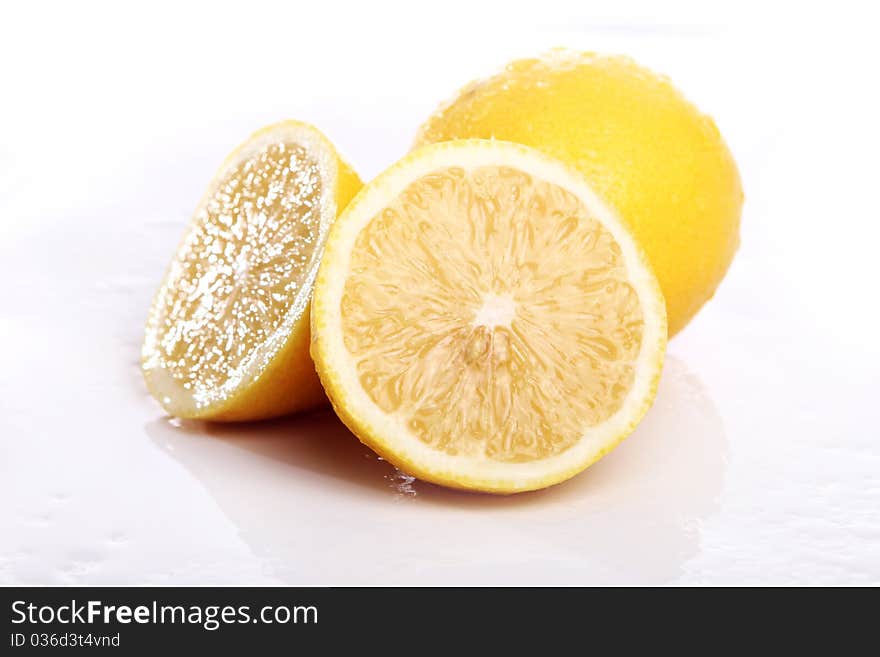 Fresh and wet lemon on white background. Fresh and wet lemon on white background