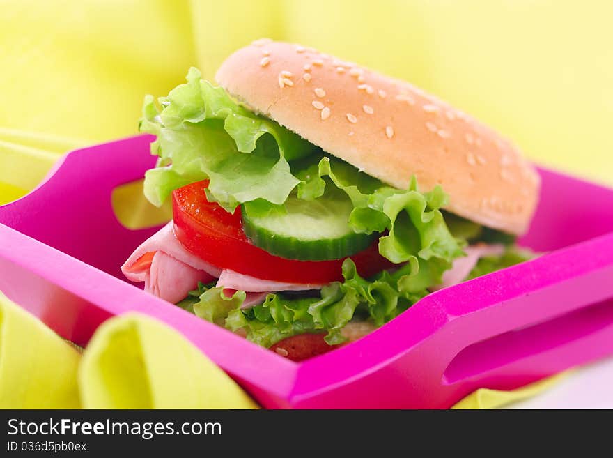 Sandwich with ham, tomato and cucumber on tray