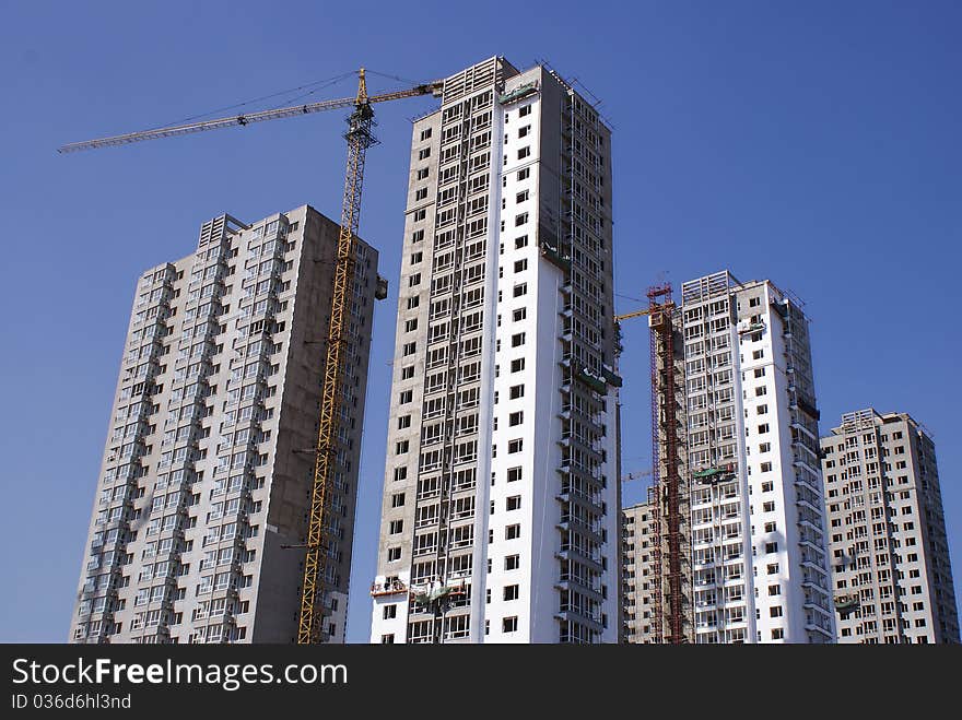 HIGH-RISE UNDER CONSTRUCTION IN BLUE SKY. HIGH-RISE UNDER CONSTRUCTION IN BLUE SKY