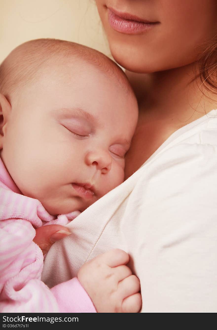 Beautiful little girl asleep on mother's chest. Beautiful little girl asleep on mother's chest