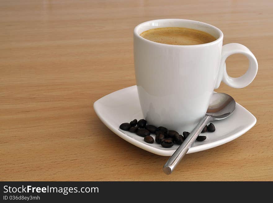 Coffee in Cup and Saucer with coffee beans