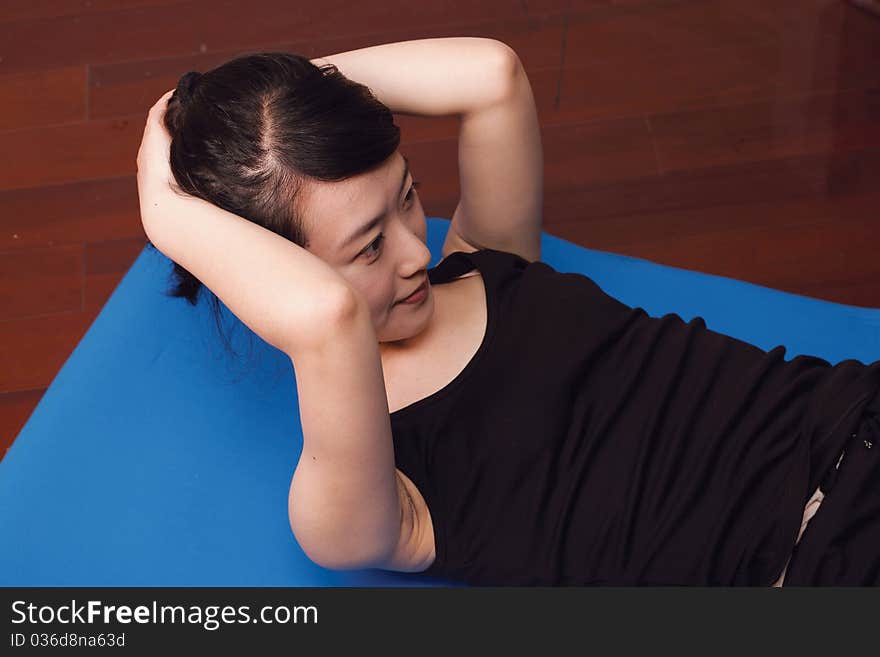 Woman doing exercise in gym