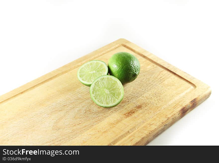 Two Limes On A Cutting Board