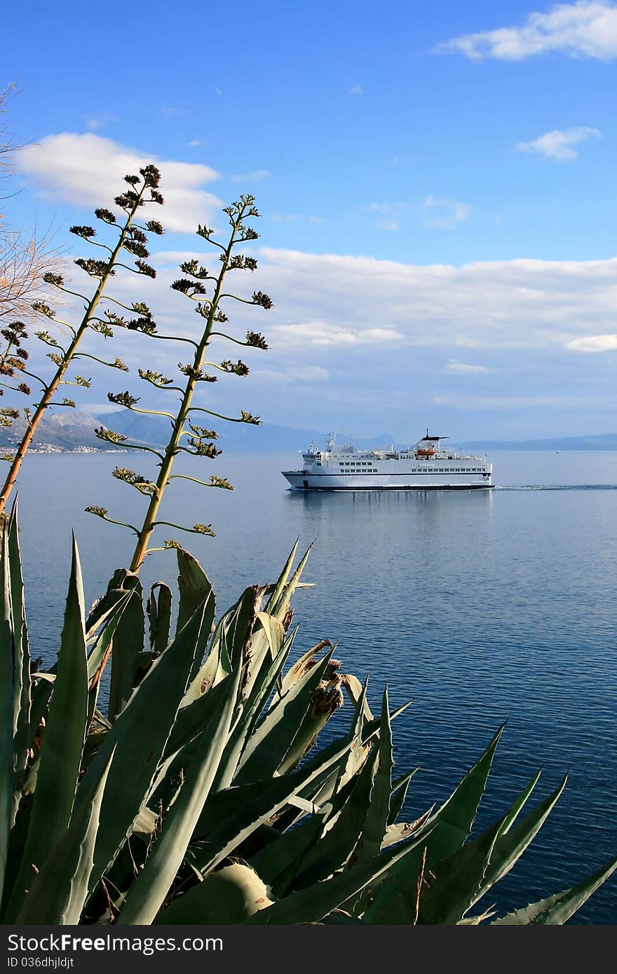 Ferry entering the coast. Blue sea and the sky in background. Ferry entering the coast. Blue sea and the sky in background.