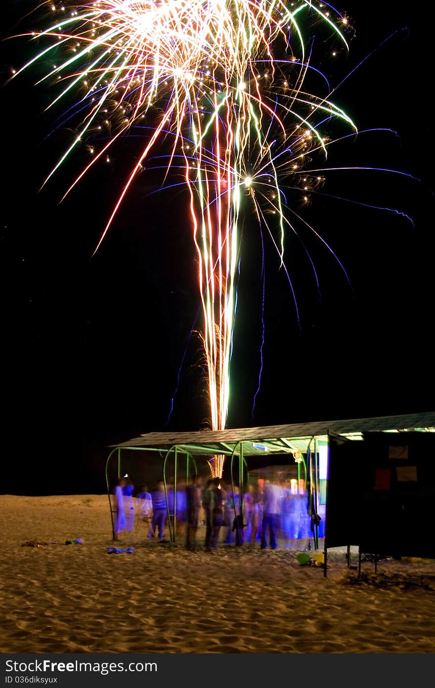 Night beach party with firework