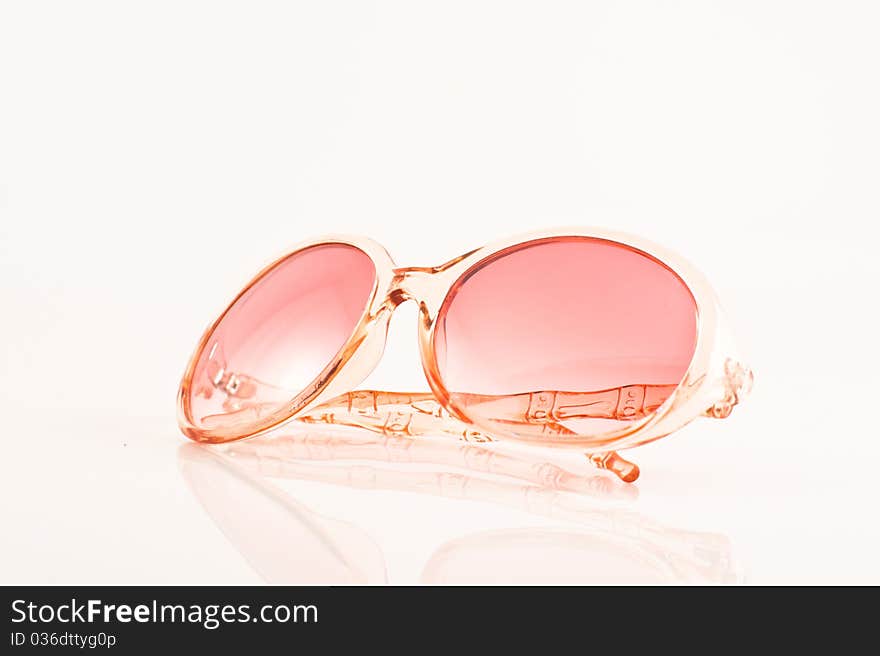 Pink sunglasses on white back ground