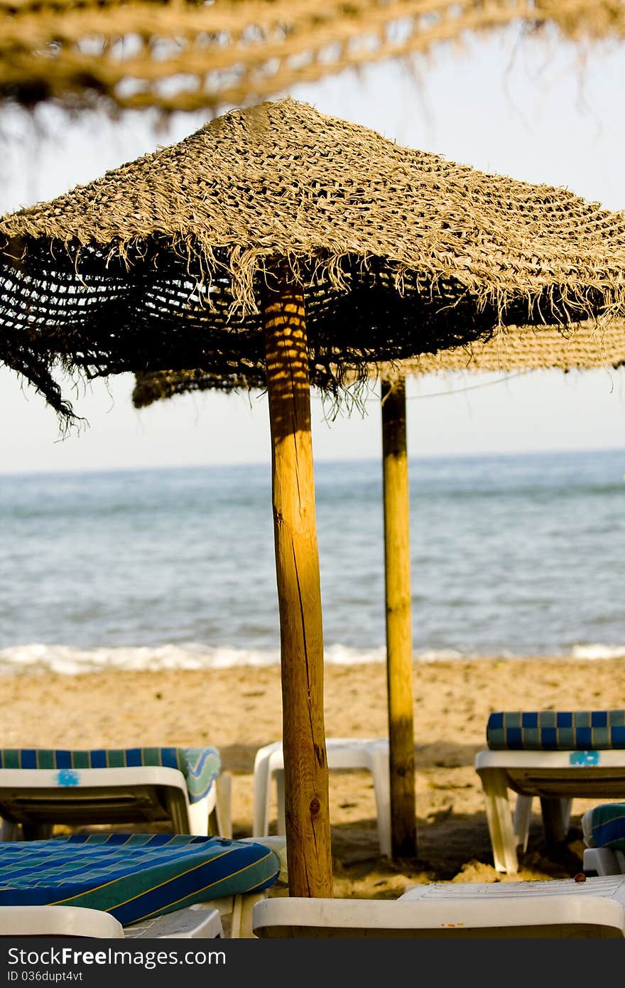 Straw Umbrella And Chairs