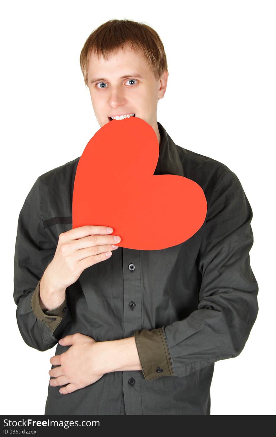 Young caucasian man bite red paper heart isolated