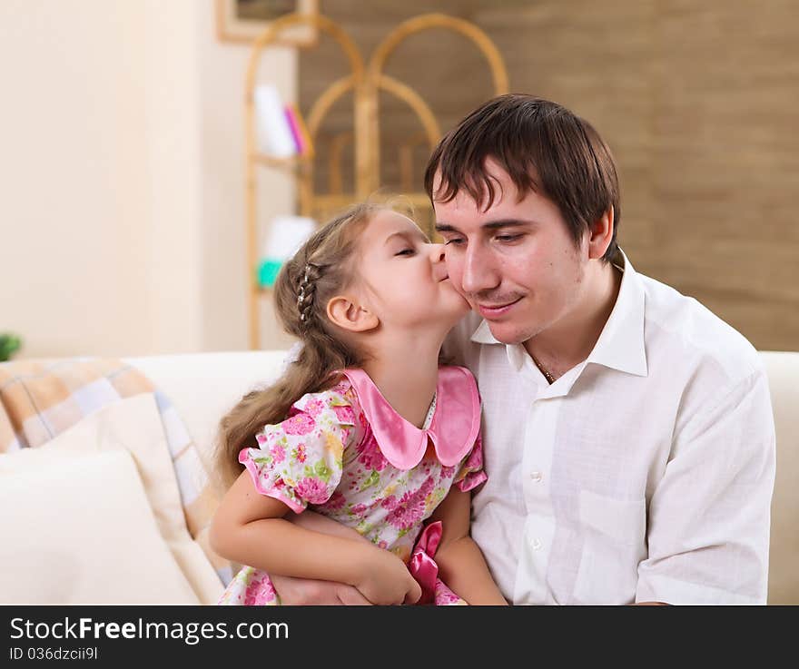 Young Family At Home With A Daughter