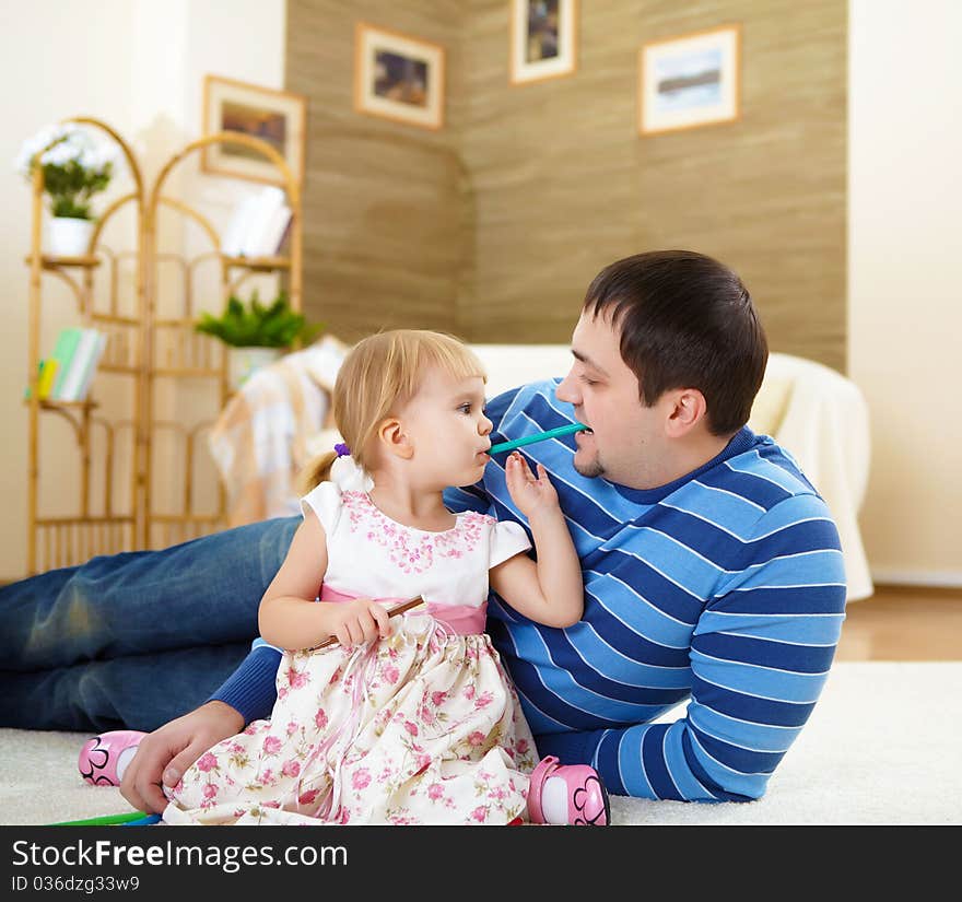 Father With His Little Daughter At Home