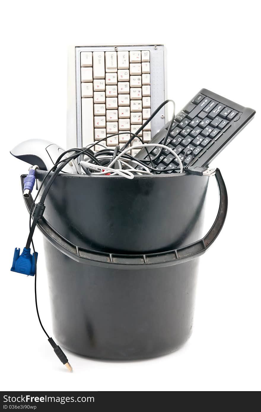 Full trash of used computer hardware. Keyboards, mouse, cables... Isolated on white. Full trash of used computer hardware. Keyboards, mouse, cables... Isolated on white