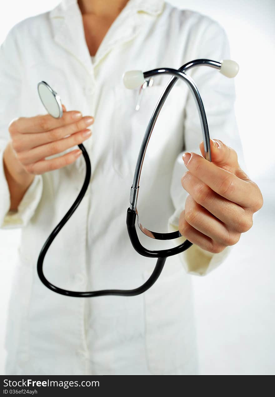 Nurse standing and giveing away her stethoscope. Nurse standing and giveing away her stethoscope