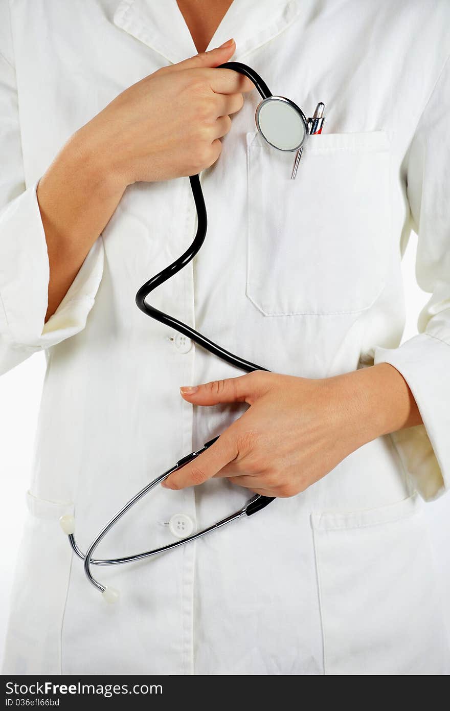 Detail of nurse standing and holding the stethoscope. Detail of nurse standing and holding the stethoscope