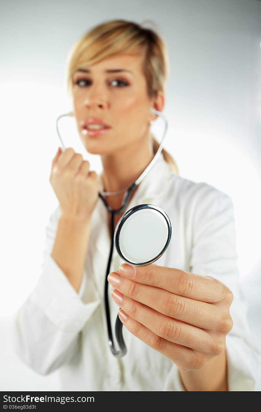 Nurse with the stethoscope in her hand ready to work with the patient. Nurse with the stethoscope in her hand ready to work with the patient