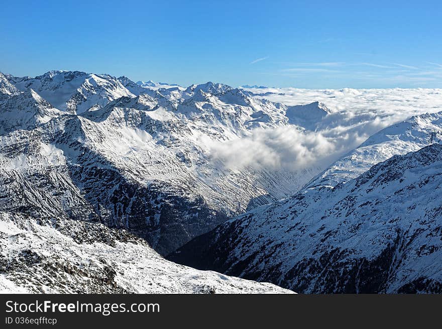 Scenic view of Austrian Alps covered with clouds. Scenic view of Austrian Alps covered with clouds.